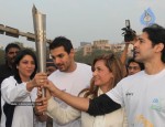 John Abraham,Maria Polyzou At Marathon Flame Run - 24 of 25